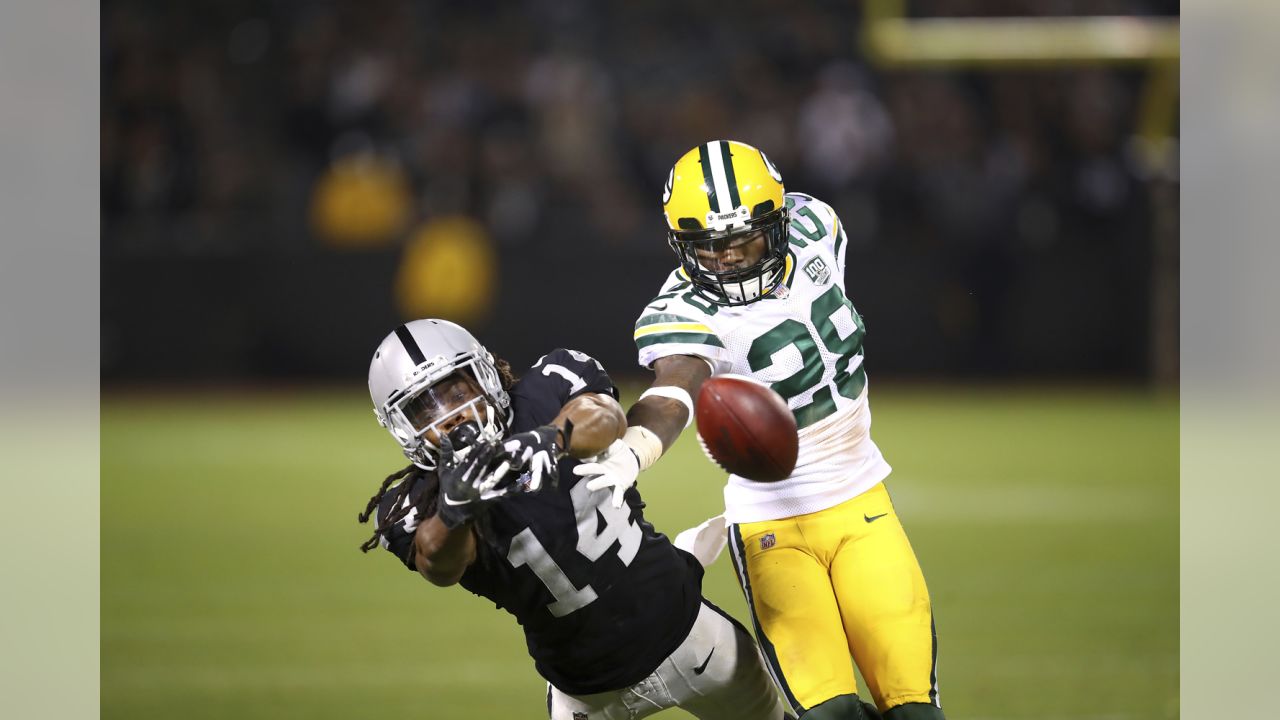 Green Bay Packers wide receiver Greg Jennings is hit by Oakland Raiders  cornerback Stanford Routt (26) and strong safety Tyvon Branch (33) during  an NFL football game Sunday, Dec. 11, 2011, in