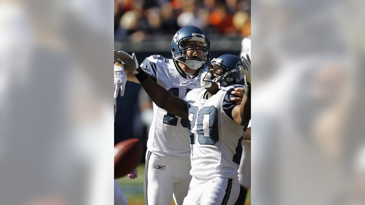 Chicago Bears wide receiver Devin Hester (23) celebrates with teammate  Corey Wootton (98) after scoring on an 89-yard punt-return in the fourth  quarter against the Seattle Seahawks of an NFL football game