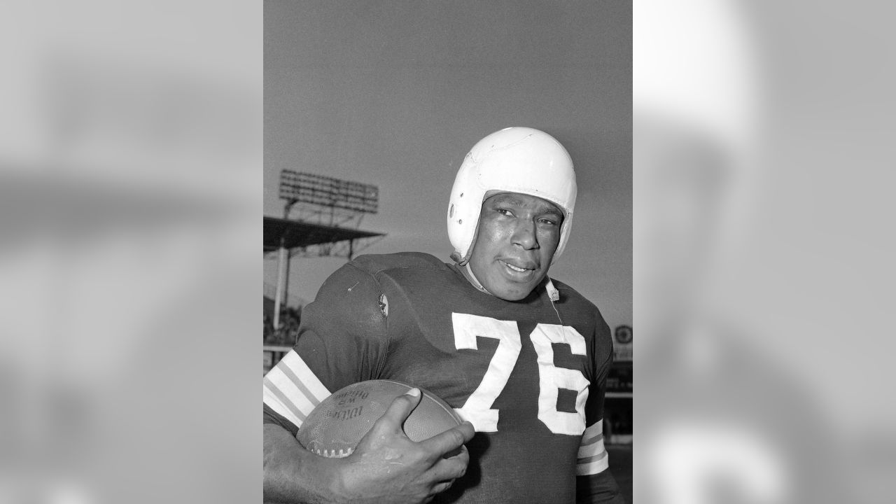 Marion Motley (76), Cleveland fullback, picked up 12 yards and a first down  in the fourth period before he was tackled by Paul Younger, Los Angeles  halfback at Cleveland on Dec. 24