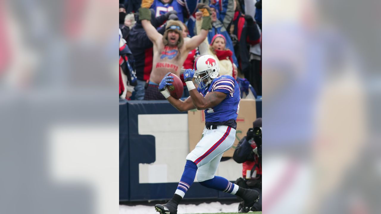 Buffalo Bills' Marshawn Lynch (23) runs under pressure from Miami Dolphins'  Joey Porter (55) during the first quarter of the NFL football game at Ralph  Wilson Stadium in Orchard Park, N.Y., Sunday