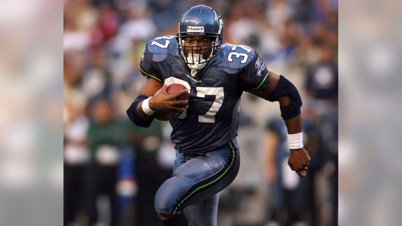 Seahawks Shaun Alexander, right, runs the ball behind a block by News  Photo - Getty Images