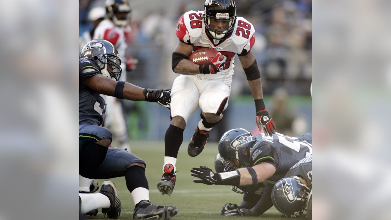 Atlanta Falcons tight end Alge Crumpler (83) is upended by Seattle Seahawks'  Marcus Trufant after a catch for short yardage in the third quarter of an  NFL football game Sunday , Dec.