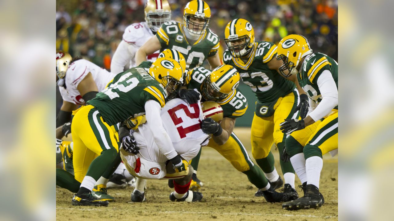 San Francisco 49ers quarterback Colin Kaepernick throws a pass during the  fourth quarter of the NFC Wildcard Playoff against the Green Bay Packers at  Lambeau Field in Green Bay, Wisconsin on January