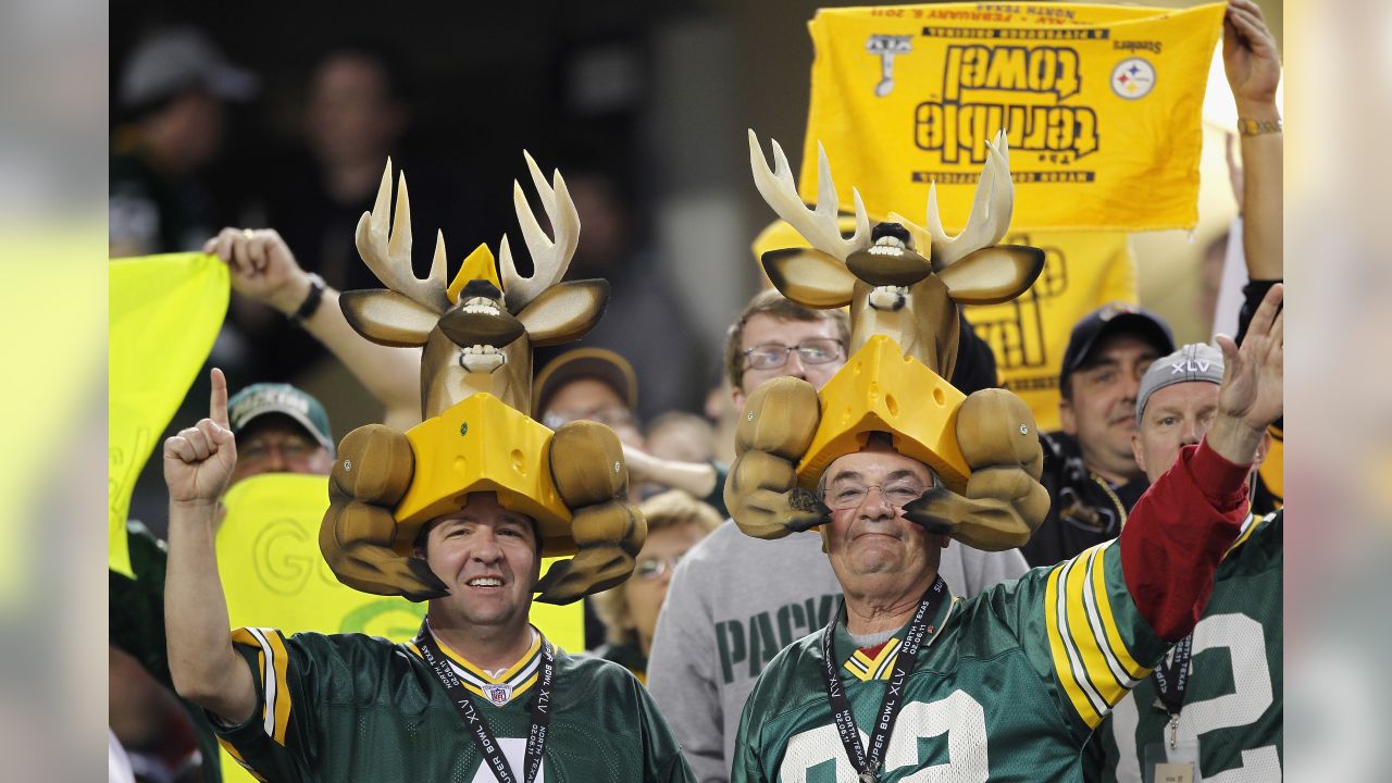 Green Bay Packers fans wear cheese hats while Buffalo Bills fans