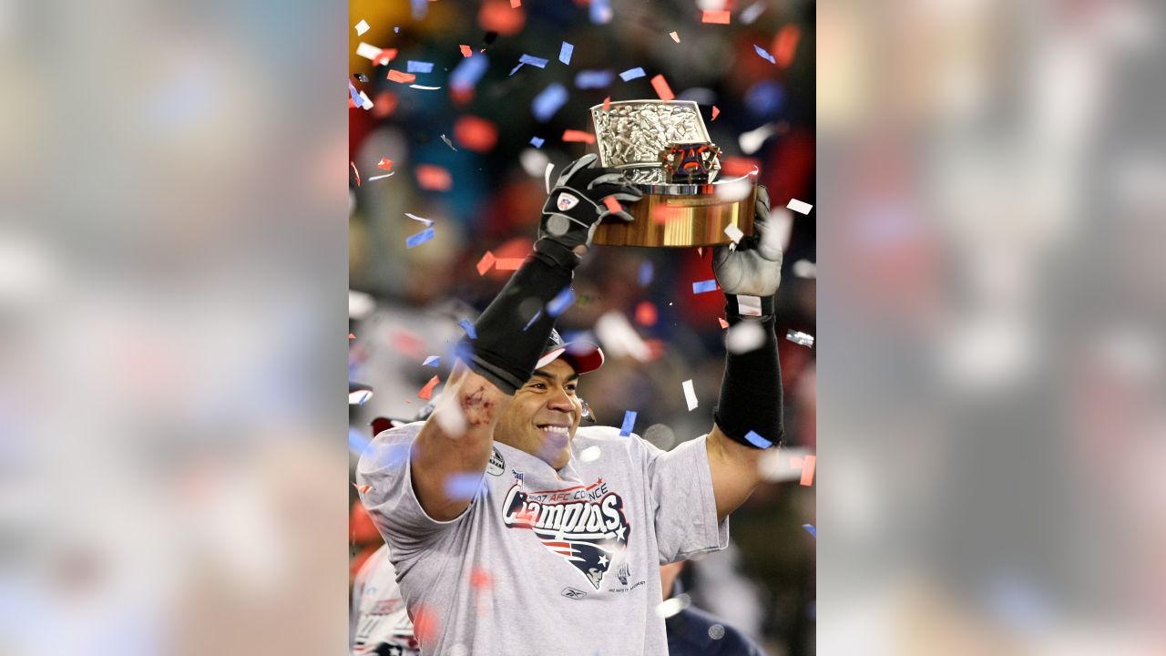 New England Patriots linebacker Junior Seau (55) hoists the AFC Championship  Lamar Hunt trophy after the team defeated the San Diego Chargers 21-12 in  the AFC Championship game at Gillette Stadium in