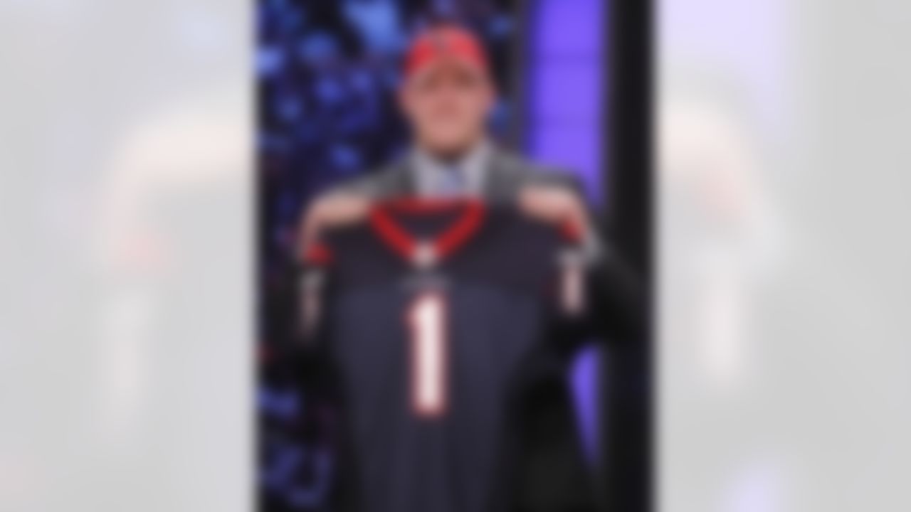 Wisconsin defensive end J.J. Watt holds up a jersey after he was selected as the 11th overall pick by the Houston Texans in the first round of the NFL football draft at Radio City Music Hall on Thursday, April 28, 2011, in New York. (AP Photo/Jason DeCrow)