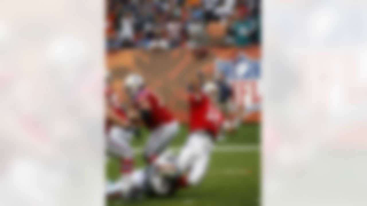 New England Patriots quarterback Tom Brady (12) is taken down by Miami Dolphins linebacker Cameron Wake during the fourth quarter of an NFL football game Sunday, Dec. 6, 2009 in Miami. Brady released the ball and it was intercepted by Miami Dolphins linebacker Channing Crowder] (not shown) to allow the Dolphins to win 22-21. (AP Photo/Wilfredo Lee)