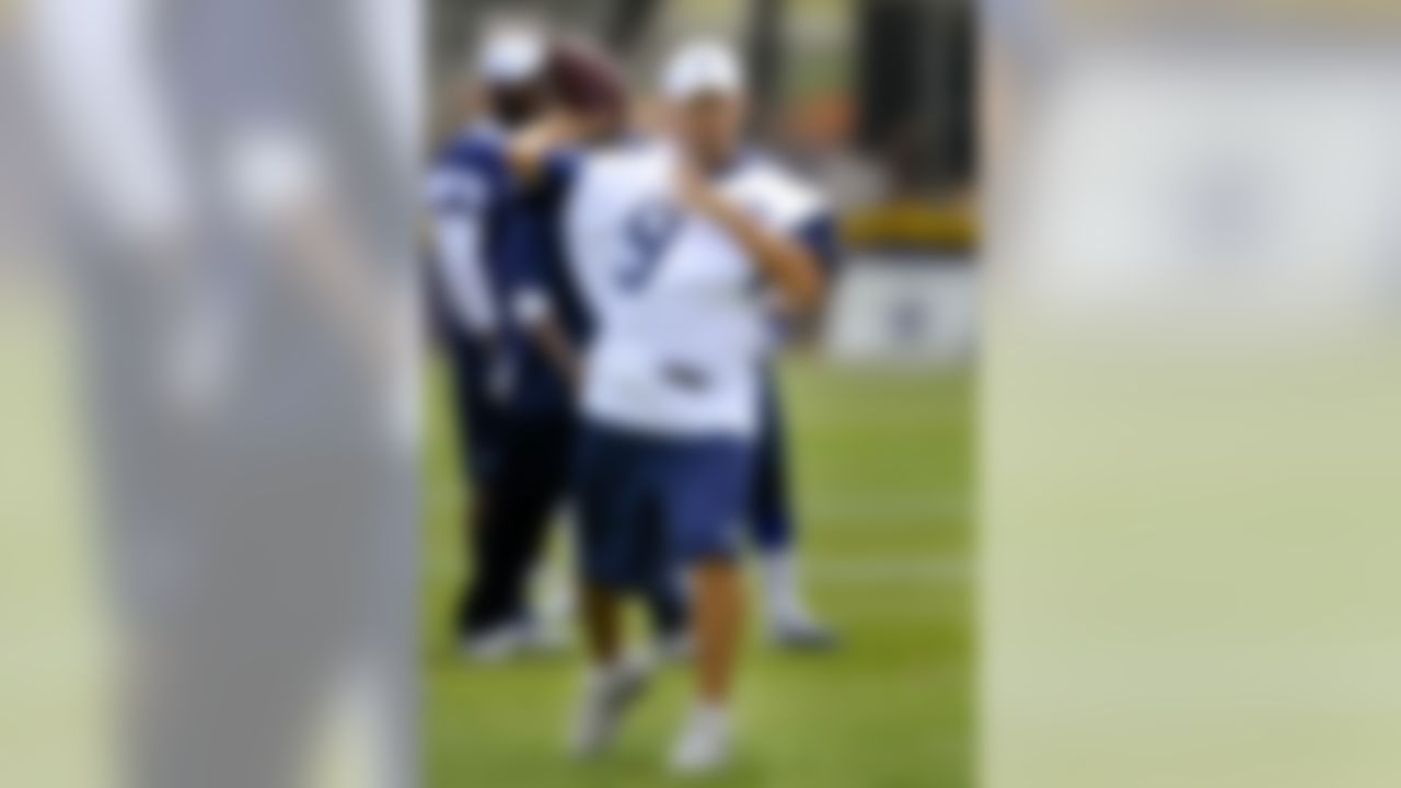 Dallas Cowboys quarterback Tony Romo throws a pass as the offense runs plays during NFL football training camp, Tuesday, July 31, 2012, in Oxnard, Calif. (AP Photo/Gus Ruelas)