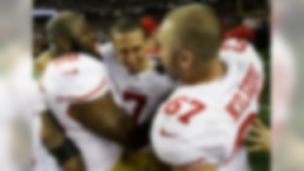 San Francisco 49ers' Colin Kaepernick (7) celebrates with Leonard Davis and Daniel Kilgore (67) after the NFL football NFC Championship game against the Atlanta Falcons Sunday, Jan. 20, 2013, in Atlanta. The 49ers won 28-24 to advance to Superbowl XLVII. (AP Photo/Dave Martin)