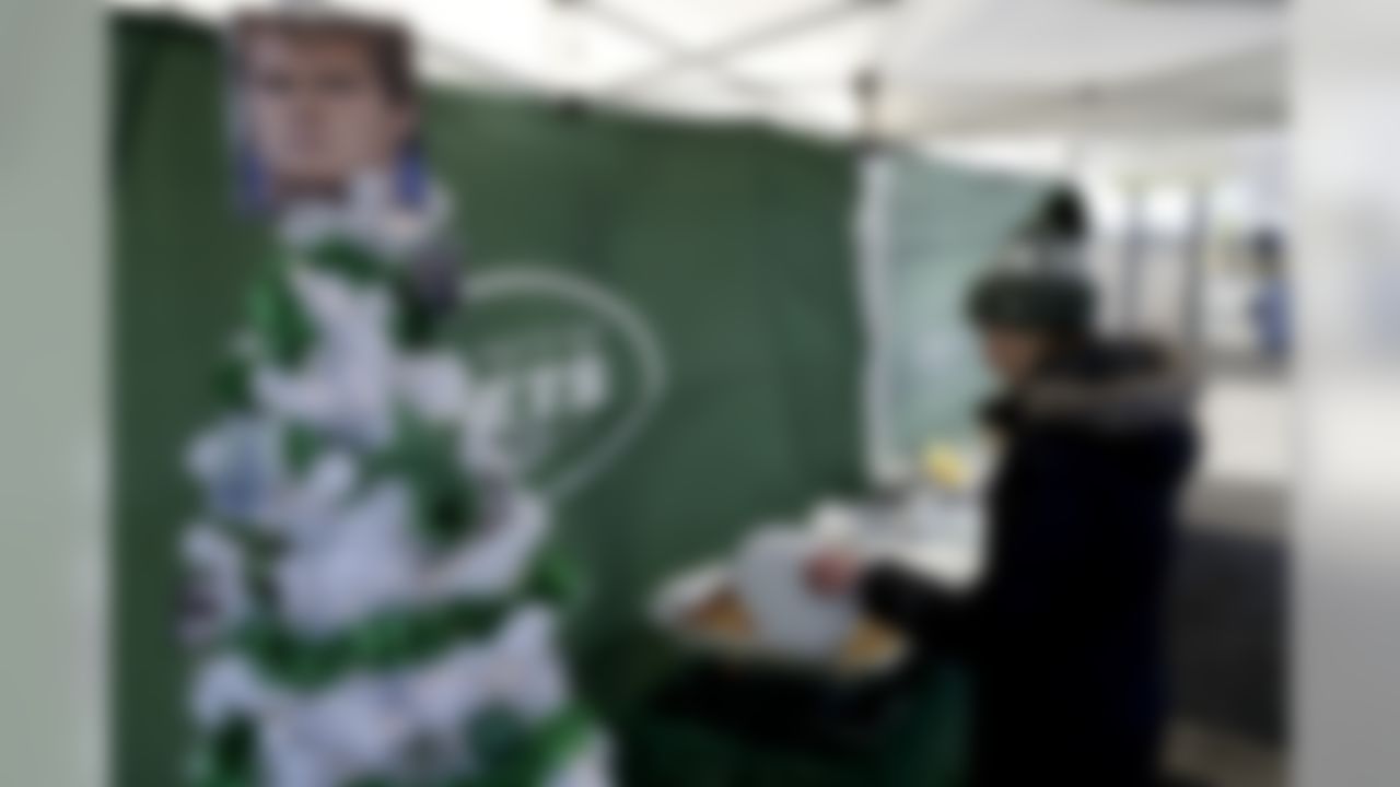 A photograph of New York Jets quarterback Sam Darnold tops a Christmas tree at a tailgate party prior to an NFL football game between the Green Bay Packers and the Jets, Sunday, Dec. 23, 2018, in East Rutherford, N.J. (AP Photo/Julio Cortez)