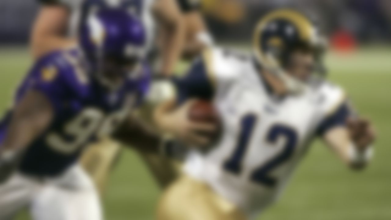 St. Louis Rams quarterback Ryan Fitzpatrick (12) leaves behind Minnesota Vikings defensive end Erasmus James (99) as he runs 14 yards for a touchdown in Minneapolis, Sunday, Dec. 11, 2005.
