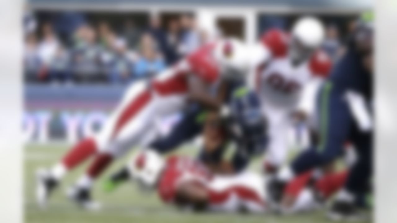 Seattle Seahawks quarterback Russell Wilson (3) is sacked by defensive end Darnell Dockett (90) in the first half of an NFL football game, Sunday, Nov. 23, 2014, in Seattle. (AP Photo/Elaine Thompson)