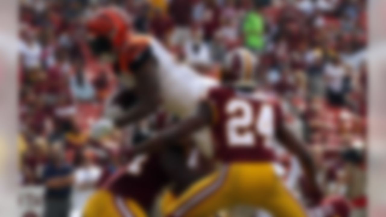 Cincinnati Bengals running back Jeremy Hill, left, dives into the end zone for a touchdown in front of Washington Redskins cornerback Josh Norman (24) in the first half of a preseason NFL football game, Sunday, Aug. 27, 2017, in Landover, Md. (AP Photo/Alex Brandon)