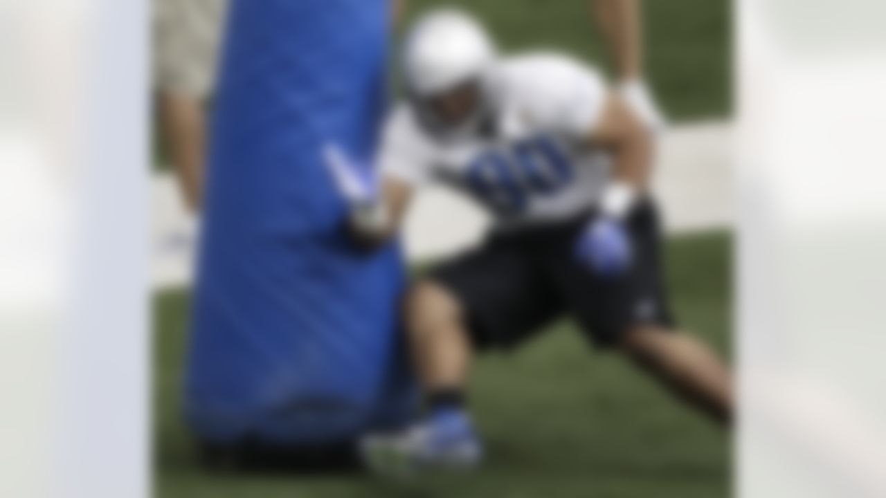 Detroit Lions defensive tackle Ndamukong Suh runs a drill during their NFL football training camp practice at the teams indoor training facility in Allen Park, Mich., Friday, July 29, 2011. (AP Photo/Paul Sancya)