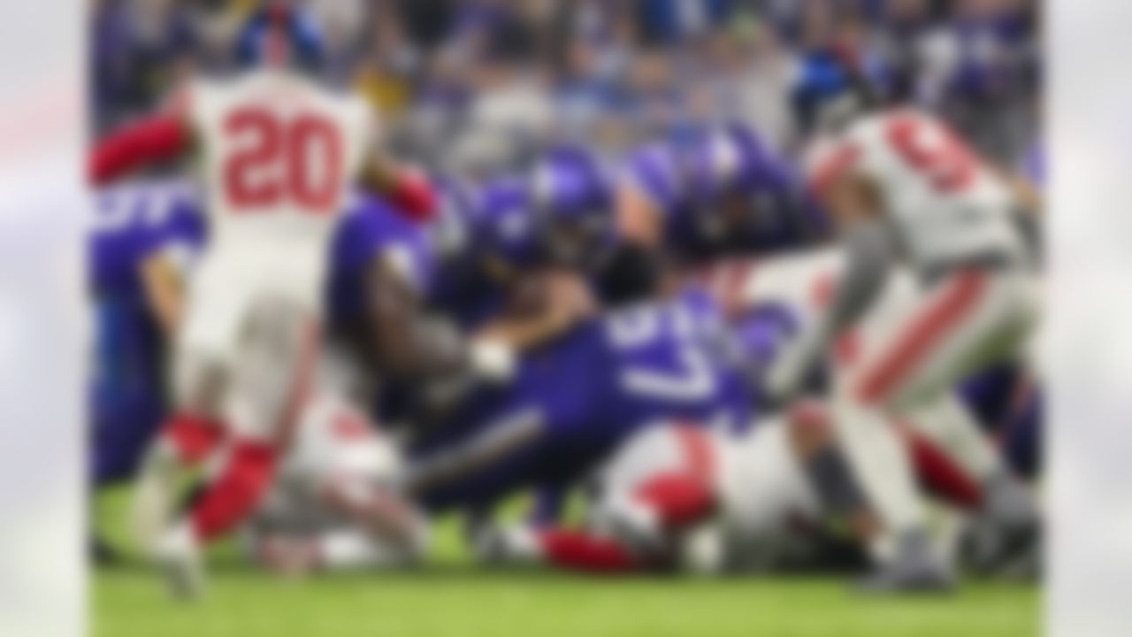 Minnesota Vikings quarterback Kirk Cousins (8) dives over the pile during an NFL Super Wild Card Weekend playoff game against the New York Giants on Sunday, January 15, 2023 in Minneapolis, Minnesota.
