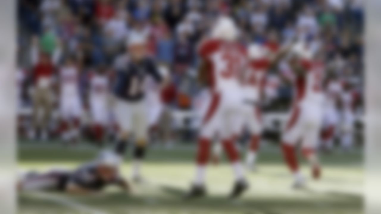 New England Patriots kicker Stephen Gostkowski (3) lies on the field alongside Arizona Cardinals cornerback Justin Bethel (31) after missing a field at the end of the fourth quarter of an NFL football game on Sunday, Sept. 16, 2012, in Foxborough, Mass. Patriot's Zoltan Mesko (14), the holder on the play, reacts. The Cardinals won 20-18. (AP Photo/Elise Amendola)