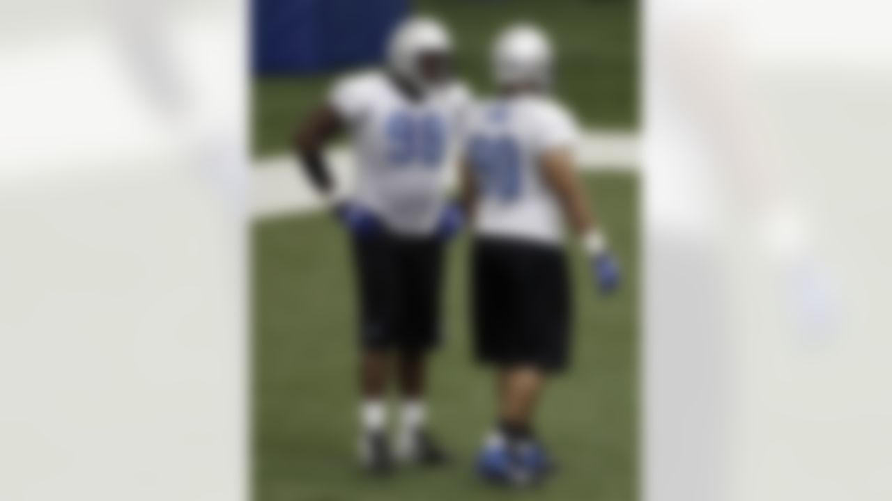 Detroit Lions defensive tackle Nick Fairley, left, asks Ndamukong Suh, right, a question during NFL football training camp at the team's indoor training facility in Allen Park, Mich., Friday, July 29, 2011. (AP Photo/Paul Sancya)