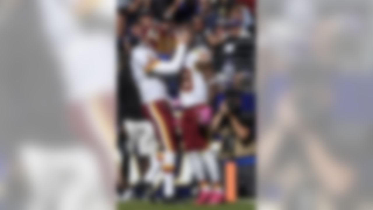 Washington Redskins' Kirk Cousins, left, and Pierre Garcon celebrate after Garcon's touchdown during the second half of an NFL football game against the Baltimore Ravens, Sunday, Oct. 9, 2016, in Baltimore. (AP Photo/Nick Wass)