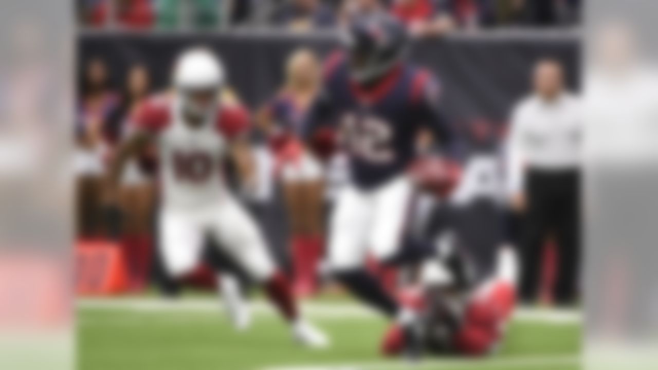 Houston Texans' Bruce Ellington (12) fields a punt as Arizona Cardinals' Brittan Golden (10) and Budda Baker (36) contain him during the first half of an NFL football game, Sunday, Nov. 19, 2017, in Houston. (AP Photo/Eric Christian Smith)