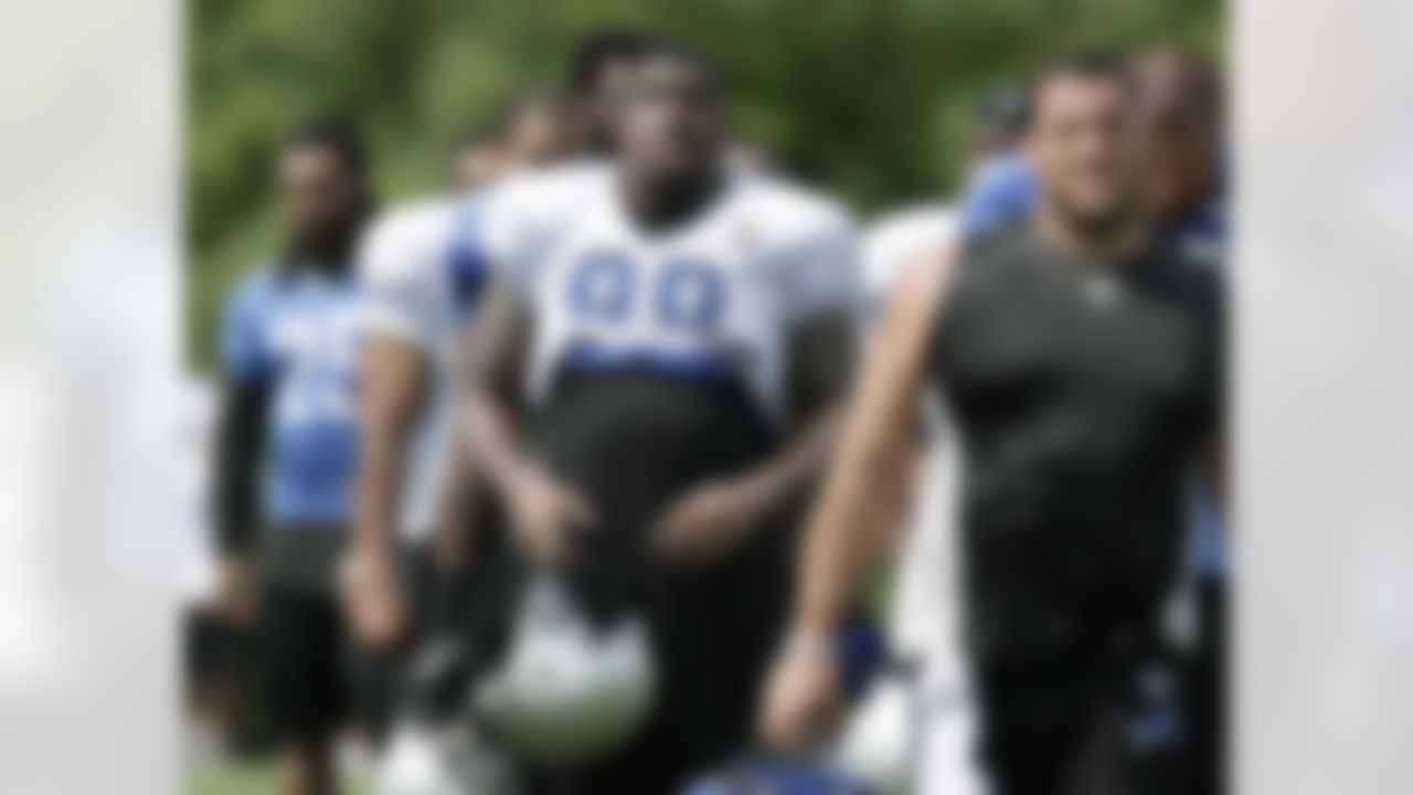 Detroit Lions defensive end Nick Fairley, center, walks off the field with teammates following practice at NFL football training camp, Thursday, Aug 2, 2012, in Allen Park, Mich. (AP Photo/Duane Burleson)