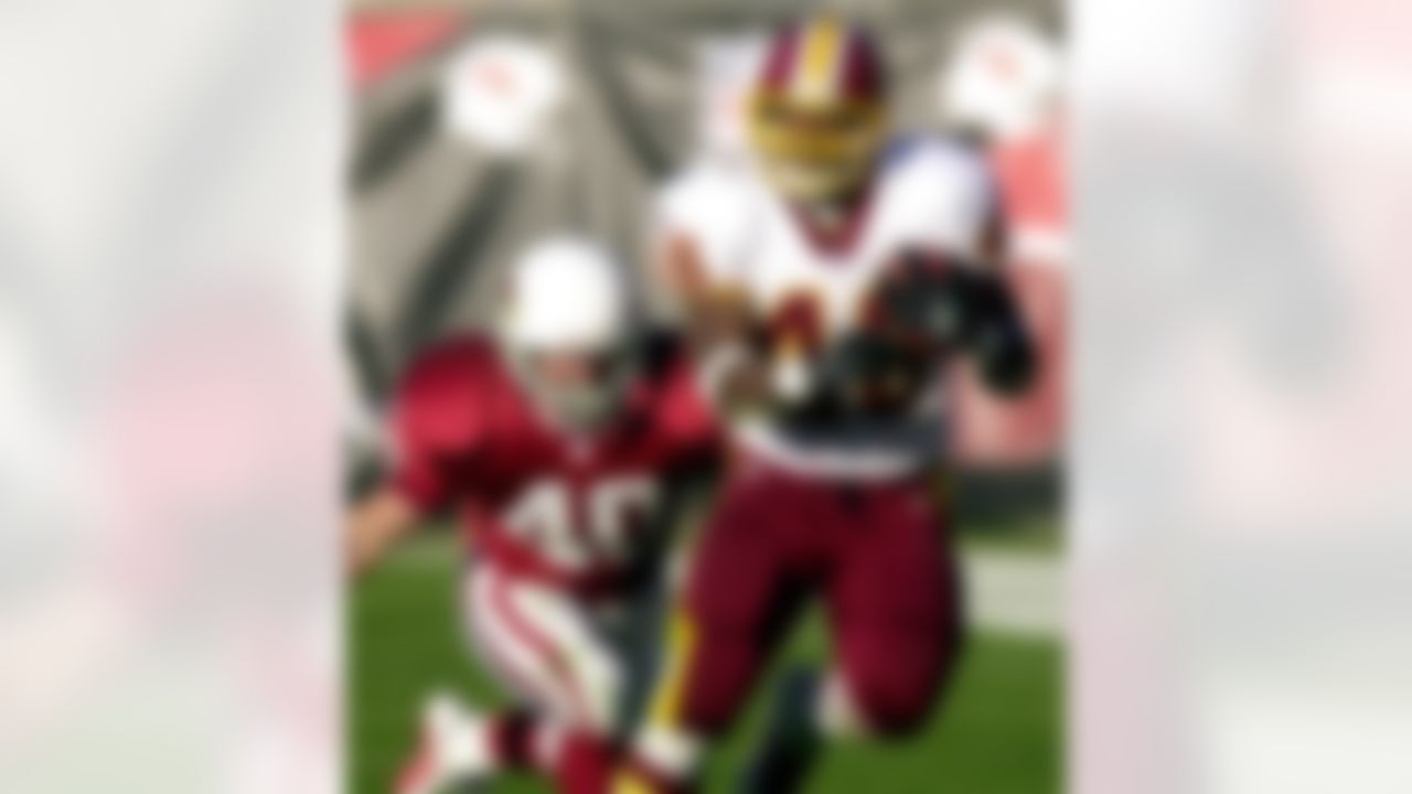 Washington Redskins running back Stephen Davis, right, gains yardage as Arizona Cardinals' Pat Tillman defends during the second quarter in this Dec. 9, 2001 photo, at Sun Devil Stadium in Tempe, Ariz. (AP Photo/Paul Connors)