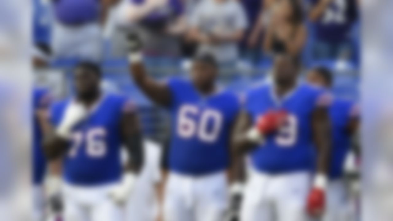 Buffalo Bills tackle Cameron Jefferson (60) raises his fist during a rendition of the national anthem before a preseason NFL football game against the Baltimore Ravens, Saturday, Aug. 26, 2017, in Baltimore. (AP Photo/Nick Wass)
