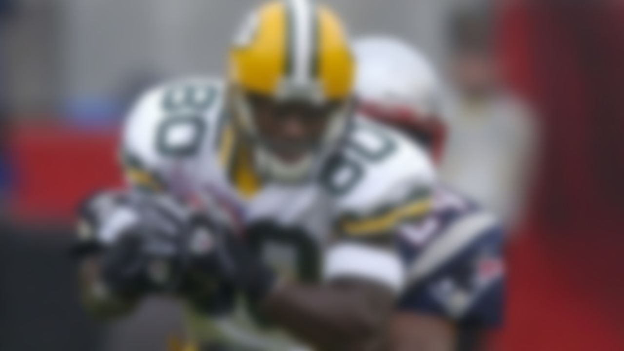 Donald Driver of the Green Bay Packers is tackled by Ty Law of the New England Patriots on Sunday, Oct. 13, 2002, in Foxborough, Mass. The Packers defeated the Patriots 28-19.