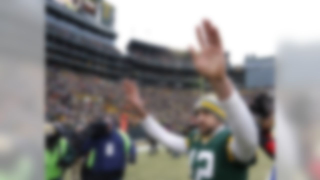 Green Bay Packers quarterback Aaron Rodgers waves to fans after an NFL divisional playoff football game against the Dallas Cowboys Sunday, Jan. 11, 2015, in Green Bay, Wis. The Packers won 26-21. (AP Photo/Matt Ludtke)