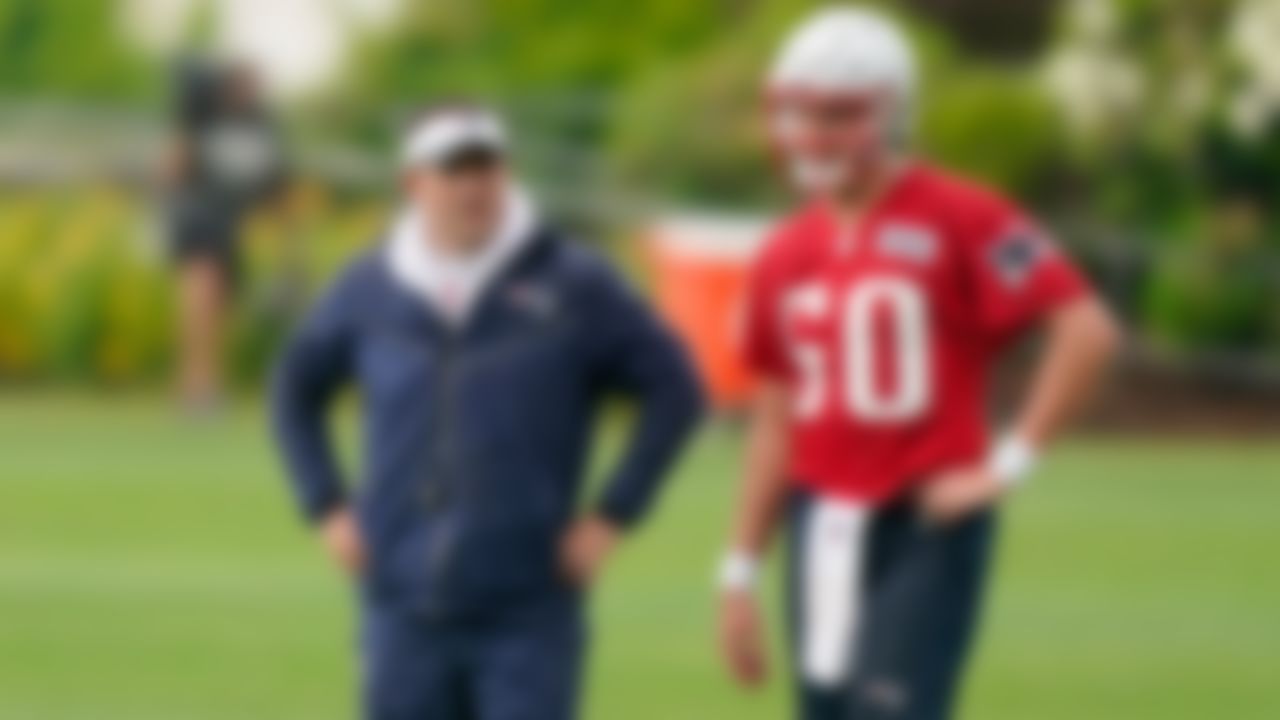 New England Patriots offensive coordinator Josh McDaniels, left, speaks with quarterback Mac Jones (50) on Monday, June 14, 2021, in Foxborough, Mass.