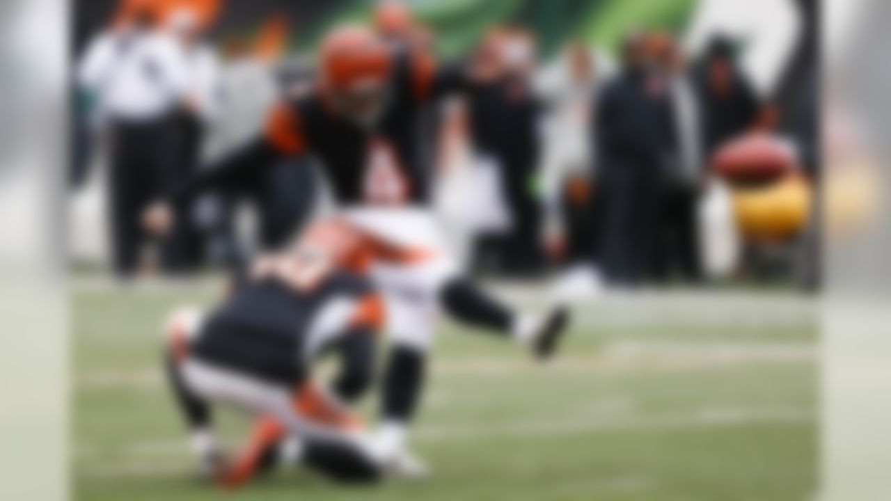 Cincinnati Bengals kicker Randy Bullock (4) boots a field goal alongside punter Kevin Huber (10) in the first half of an NFL football game against the Pittsburgh Steelers, Sunday, Dec. 18, 2016, in Cincinnati. (AP Photo/Gary Landers)