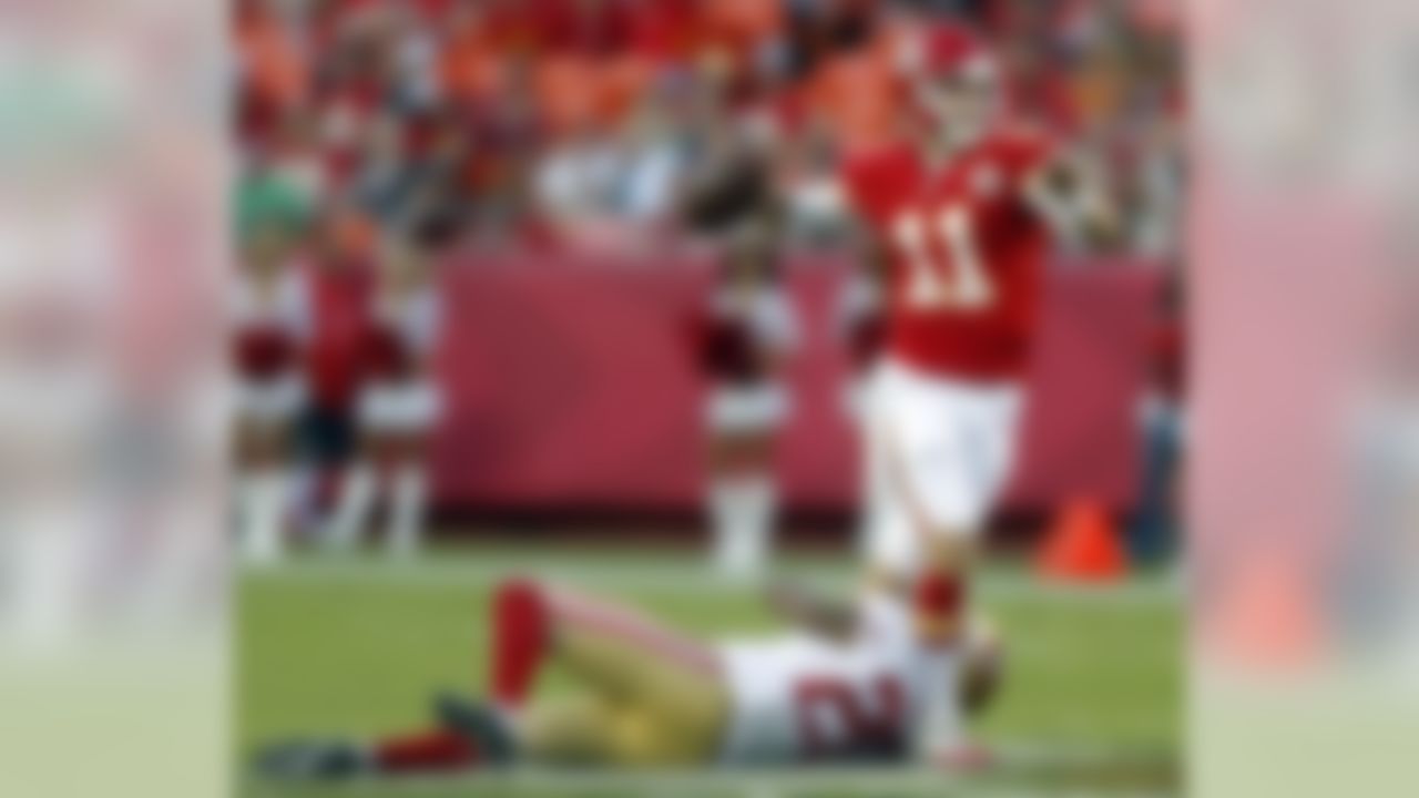 Kansas City Chiefs quarterback Alex Smith (11) passes while pressured by San Francisco 49ers defensive back Perrish Cox (20) during the first half of an preseason NFL football game at Arrowhead Stadium in Kansas City, Mo., Friday, Aug. 16, 2013. (AP Photo/Ed Zurga)