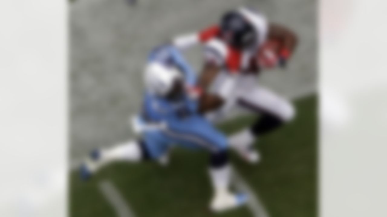 Houston Texans running back Ben Tate (44) rushes for a first down as Tennessee Titans outside linebacker Zach Brown (55) tries to tackle him during the first quarter of an NFL football game on Sunday, Sept. 15, 2013, in Houston. The Texans defeated the Titans 30-24 in overtime. (AP Photo/David J. Phillip)