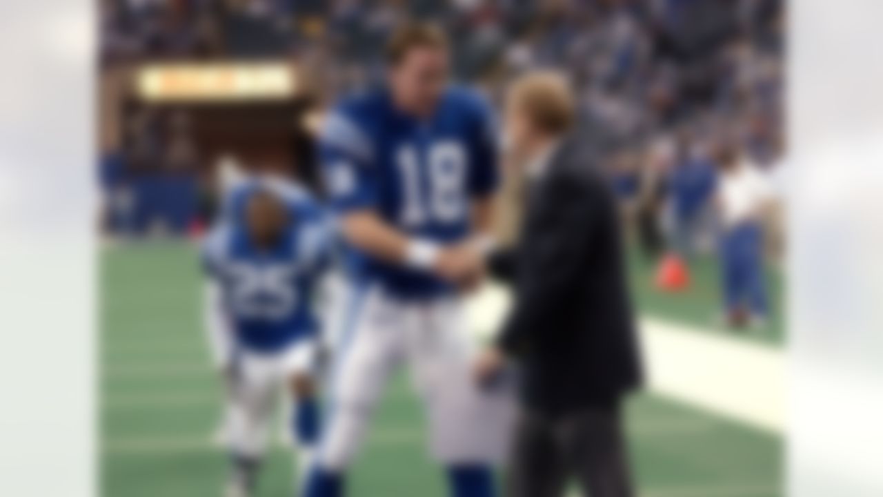 23 Dec 2001: Quarterback Peyton Manning #18 of the Indianapolis Colts shakes hands with general manager Bill Polian during warm-ups before the game against the New York Jets at the RCA Dome in Indianapolis, Indiana. The Jets won 29-28. Photo by Ron Hoskins/Getty Images.