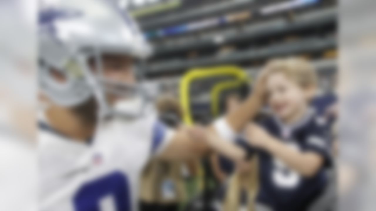 Dallas Cowboys quarterback Tony Romo (9) greets his son, Hawkins before a preseason NFL football game Minnesota Vikings Saturday, Aug. 29, 2015, in Arlington, Texas. (AP Photo/Brandon Wade)