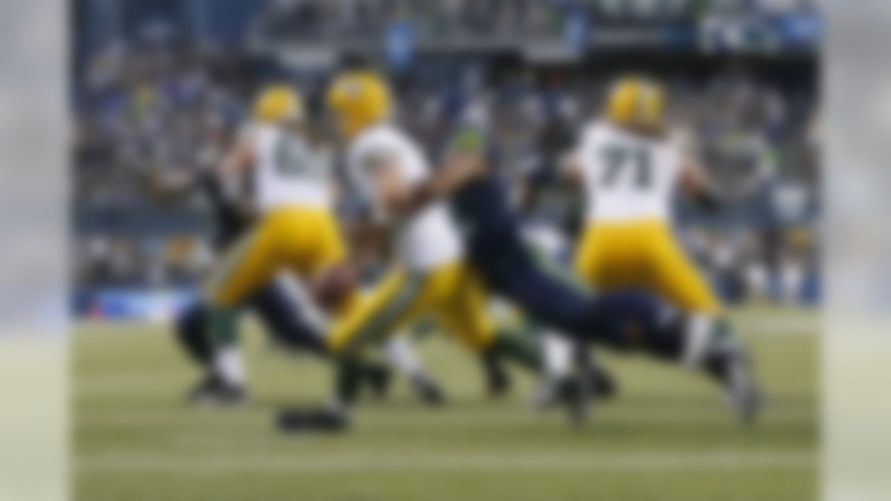 Seattle Seahawks defensive end Michael Bennett (72) sacks Green Bay Packers quarterback Aaron Rodgers (12) at CenturyLink Field during an NFL game on Thursday, Sept. 4, 2014 in Seattle.  (Ben Liebenberg/NFL)