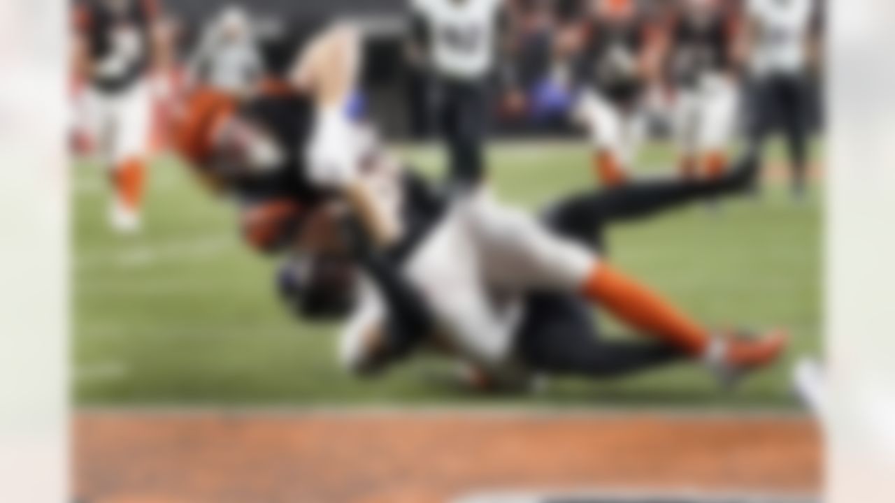 Cincinnati Bengals tight end Hayden Hurst, front, is stopped short of the goal line by Baltimore Ravens safety Chuck Clark in the second half of an NFL wild-card playoff football game in Cincinnati, Sunday, Jan. 15, 2023.