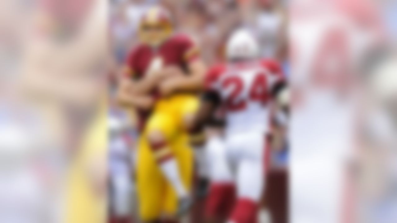 Washington Redskins kicker Graham Gano, left, is lifted up by teammate Sav Rocca after making a field goal in the second half of an NFL football game against the Arizona Cardinals in Landover, Md., Sunday, Sept. 18, 2011. Washington won 22-21. Cardinals strong safety Adrian Wilson (24) looks on. (AP Photo/Nick Wass)