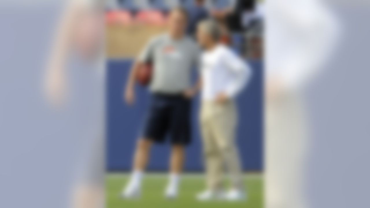 Denver Broncos quarterback Peyton Manning, left, talks with Seattle Seahawks head coach Pete Carroll, right, during warmups before their NFL football preseason game on Saturday, Aug. 18, 2012, in Denver. (AP Photo/Jack Dempsey)