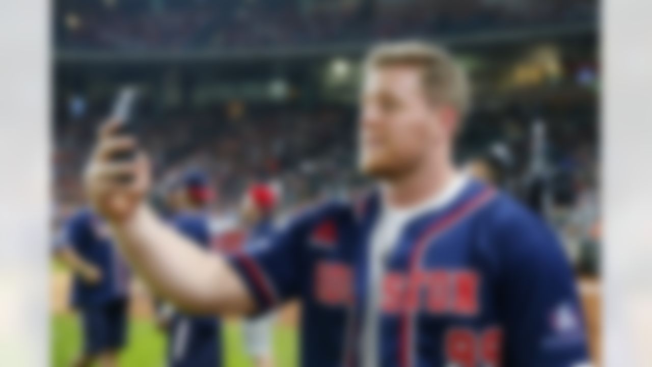 Houston Texans defensive end J.J. Watt (99) self videos a message on a phone for Texans social media fans during the  J.J. Watt celebrity softball game at Minute Maid Park on Saturday May 14, 2016, in Houston. (Matt Patterson via AP)