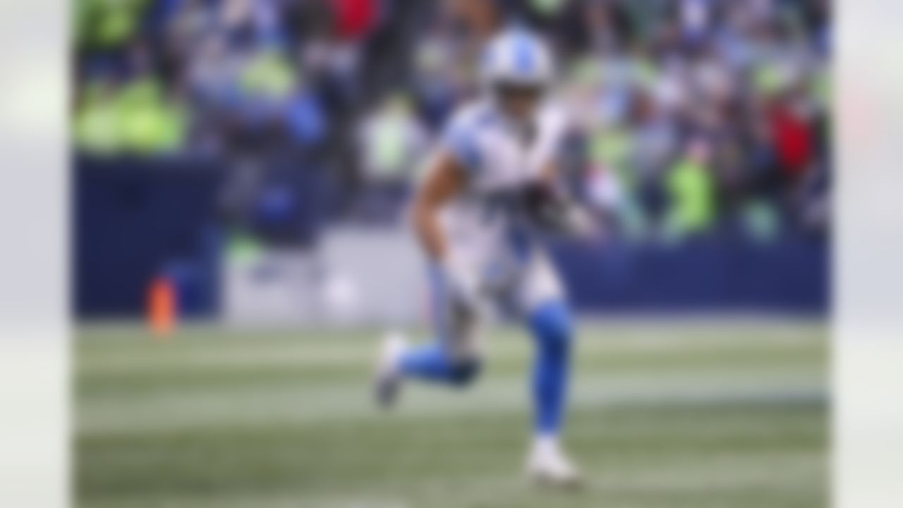 Detroit Lions wide receiver Amon-Ra St. Brown (14) runs with the ball during an NFL football game against the Detroit Lions on Sunday, January 2, 2022 in Seattle, Washington.
