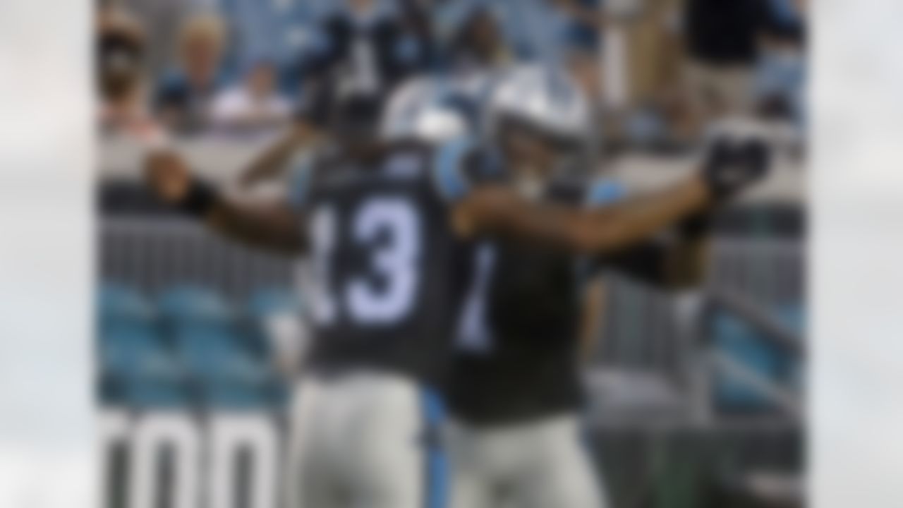 Carolina Panthers quarterback Cam Newton (1) celebrates after throwing a pass for a touchdown to wide receiver Kelvin Benjamin (13) during the first half of an NFL preseason football game against the Jacksonville Jaguars, Thursday, Aug. 24, 2017, in Jacksonville, Fla. (AP Photo/Stephen B. Morton)