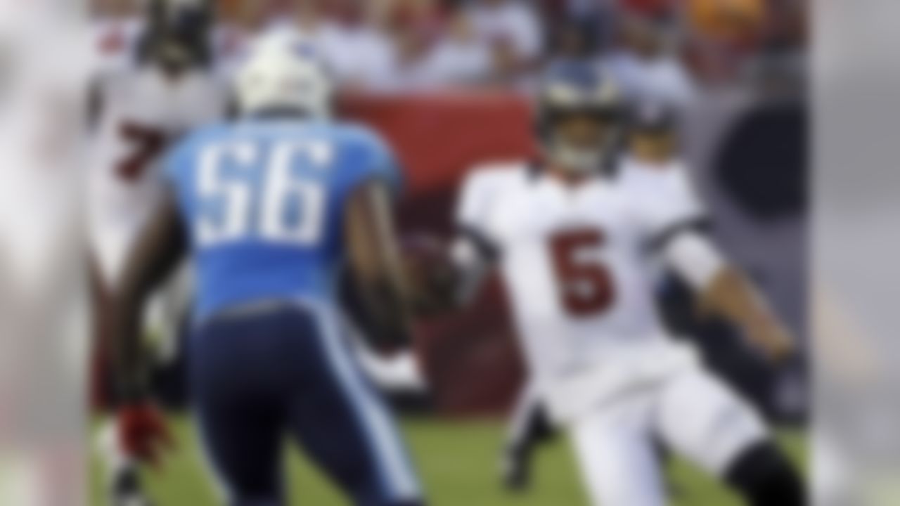 Tampa Bay Buccaneers quarterback Josh Freeman (5) slides down in front of Tennessee Titans linebacker Akeem Ayers (56) during the first quarter of an NFL preseason football game Friday, Aug. 17, 2012, in Tampa, Fla. (AP Photo/Chris O'Meara)