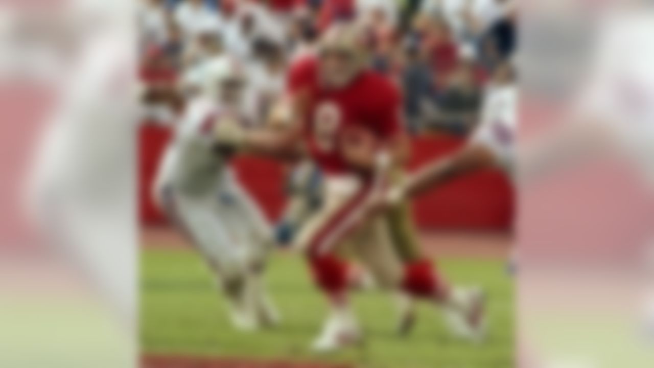 San Francisco 49ers quarterback Steve Young (8) runs to avoid sack at Stanford Stadium Sunday, October 22, 1989. .  (AP Photo/Al Golub)