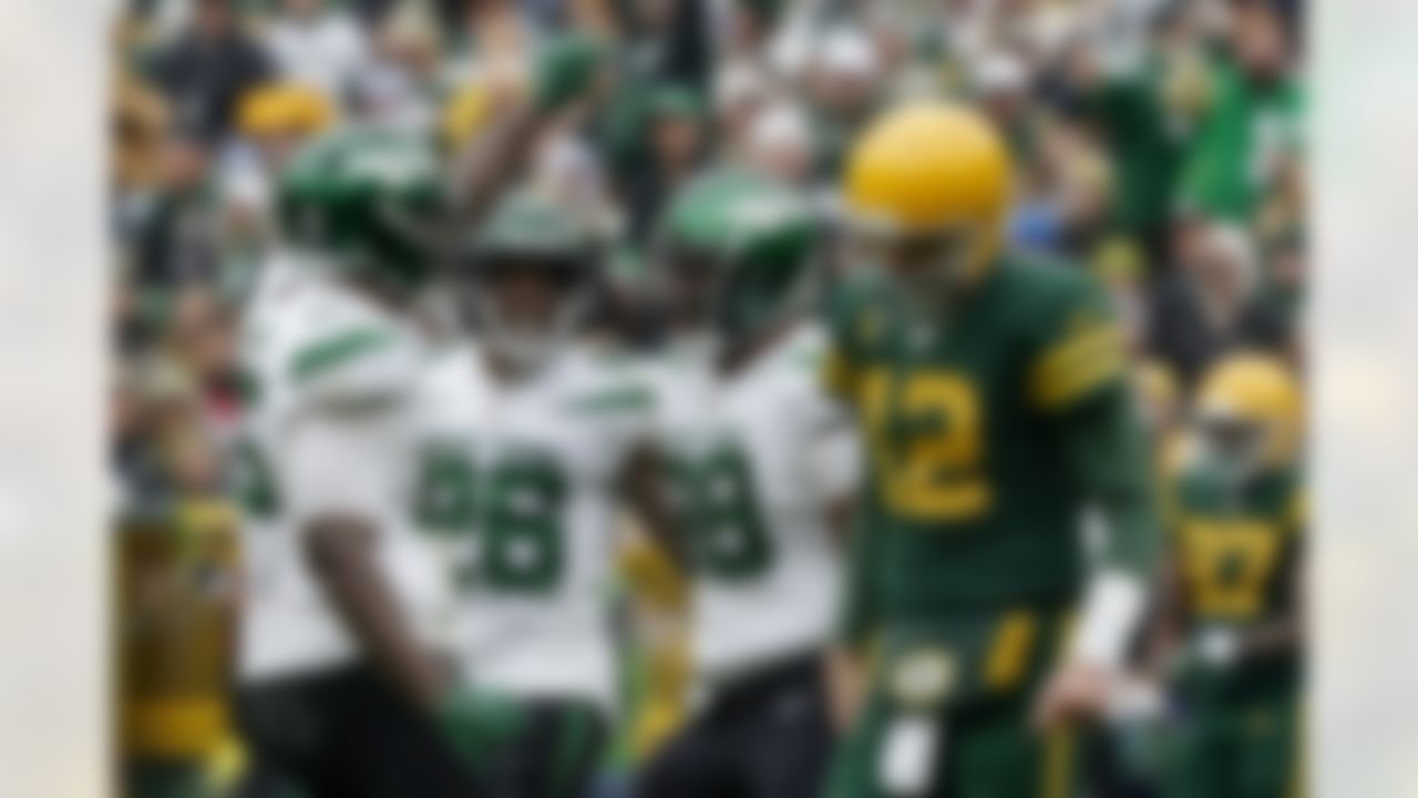 New York Jets defensive end John Franklin-Myers, left, celebrates with teammates after sacking Green Bay Packers quarterback Aaron Rodgers (12) during the second half of an NFL football game Sunday, Oct. 16, 2022, in Green Bay, Wis.