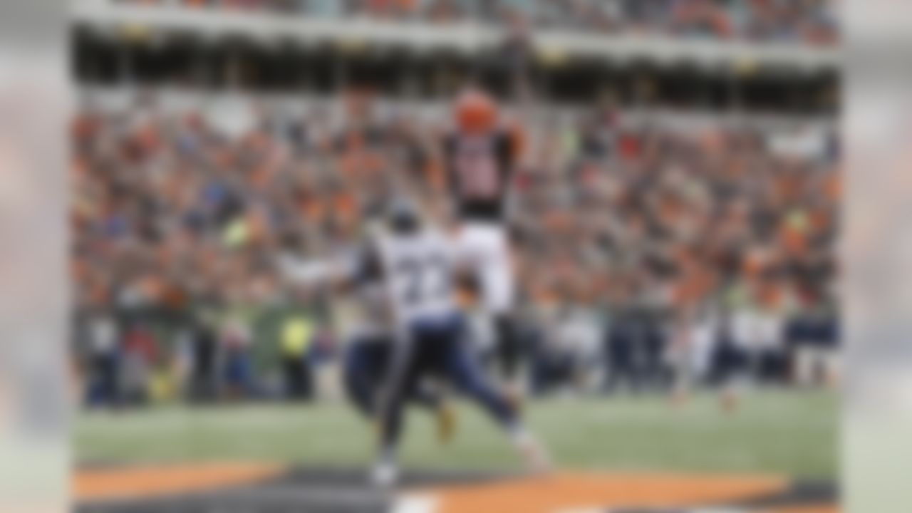 Cincinnati Bengals wide receiver A.J. Green (18) catches a touchdown pass against St. Louis Rams free safety Rodney McLeod (23) and middle linebacker James Laurinaitis (55) in the second half of an NFL football game, Sunday, Nov. 29, 2015, in Cincinnati. (AP Photo/Frank Victores)