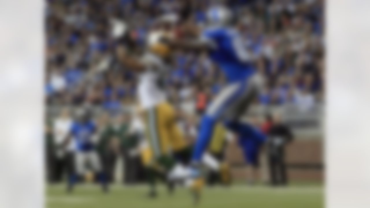 Detroit Lions wide receiver Calvin Johnson (81) pulls in a 25-yard touchdown reception as Green Bay Packers free safety Morgan Burnett (42) defends in the third quarter of their NFL football game in Detroit, Sunday, Nov. 18, 2012. (AP Photo/Carlos Osorio)