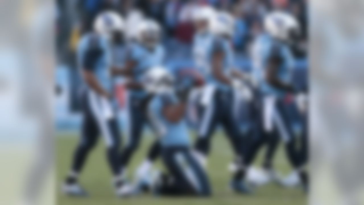 Tennessee Titans safety Michael Griffin (33) celebrates after intercepting a pass against the Houston Texans in the final minutes of the fourth quarter to seal a 16-10 win for the Titans in an NFL football game on Sunday, Dec. 29, 2013, in Nashville, Tenn. (AP Photo/Wade Payne)