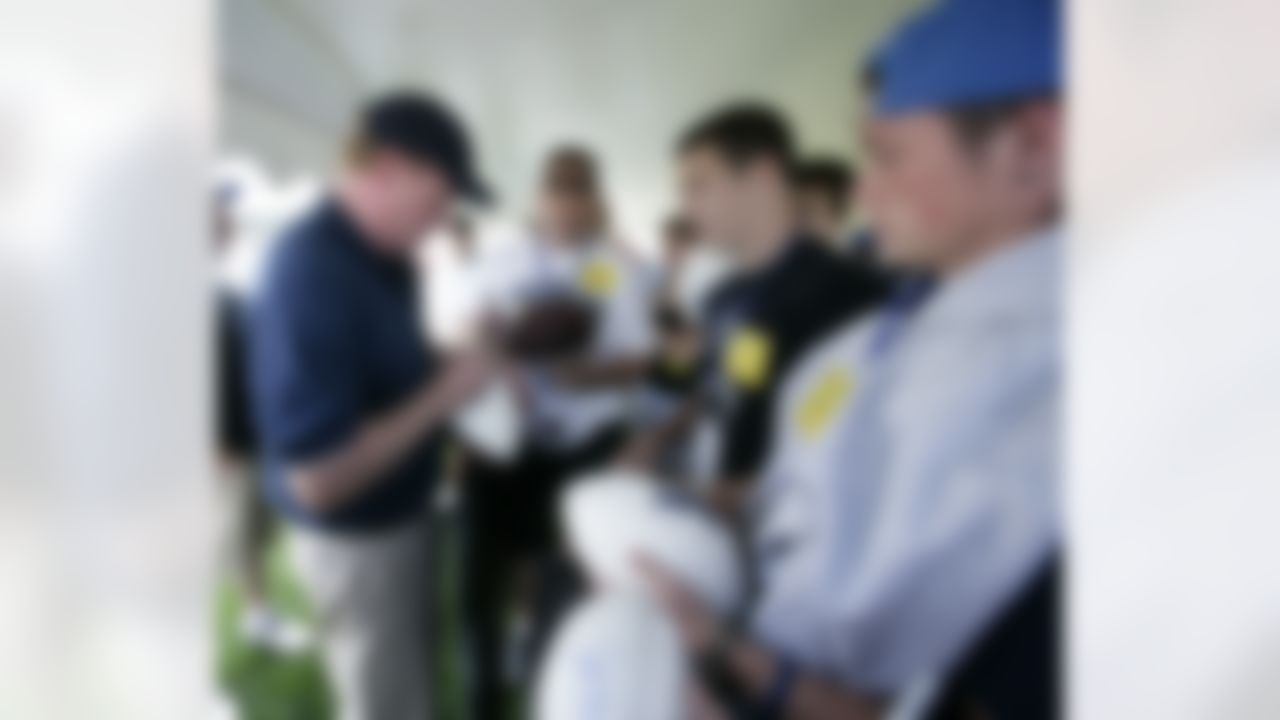 NFL Commissioner Roger Goodell takes time to sign memorabilia during his visit to the Detroit Lions NFL football training camp, Thursday, Aug 2, 2012, in Allen Park, Mich. (AP Photo/Duane Burleson)