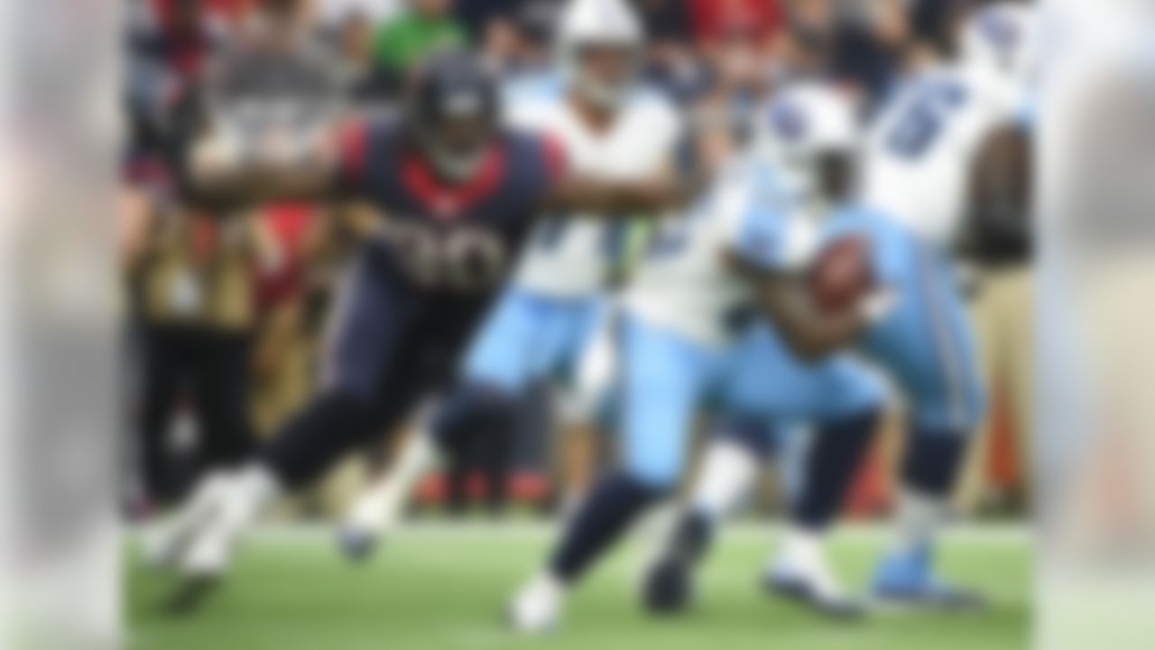 Tennessee Titans running back Antonio Andrews (26) is pursued by Houston Texans outside linebacker Jadeveon Clowney (90) during the first half of an NFL football game, Sunday, Nov. 1, 2015, in Houston. (AP Photo/Eric Christian Smith)