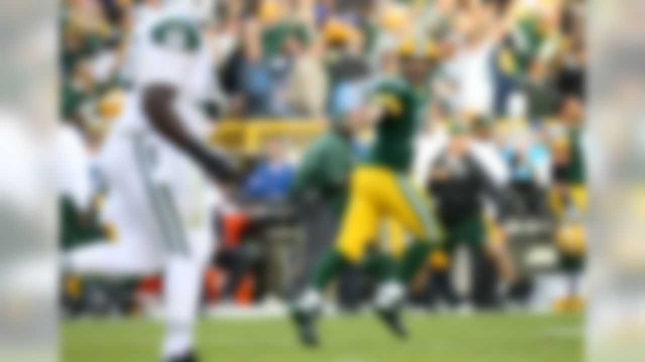 Green Bay Packers quarterback Aaron Rodgers (12) reacts to throwing a touchdown pass against the New York Jets in the third quarter on Sunday, Sept. 14, 2014, in Green Bay, Wis. (Todd Rosenberg/NFL)